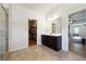 Bright bathroom with a walk-in shower, and vanity, leading to a spacious walk-in closet and bedroom at 1730 Dahlia Dr, Cumming, GA 30040