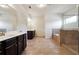 Bright bathroom featuring dual vanities, walk-in shower, and soaking tub at 1730 Dahlia Dr, Cumming, GA 30040