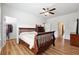 This standard bedroom includes wood floors, a bed, a dresser, and a closet at 1730 Dahlia Dr, Cumming, GA 30040