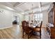 Bright dining area with light walls, coffered ceilings, wood floors, and views into the living room at 1730 Dahlia Dr, Cumming, GA 30040