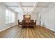 Elegant dining room with wood floors, coffered ceilings, a chandelier, and natural light from a window at 1730 Dahlia Dr, Cumming, GA 30040