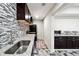Kitchenette featuring granite countertops, stainless steel appliances, and tiled backsplash at 1730 Dahlia Dr, Cumming, GA 30040