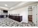 The kitchenette features wooden cabinets, granite countertops, stainless steel appliances and a backsplash at 1730 Dahlia Dr, Cumming, GA 30040
