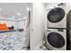 The laundry area is conveniently located near the living room and features a stacked washer and dryer at 1730 Dahlia Dr, Cumming, GA 30040