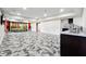 Spacious living room featuring a vibrant mural, mosaic flooring, and a kitchenette to the side at 1730 Dahlia Dr, Cumming, GA 30040