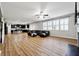 Spacious living area with a dark leather sofa, wood floors, an open floor plan, and plenty of natural light at 1730 Dahlia Dr, Cumming, GA 30040