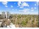 Scenic aerial view captures the building's surrounding trees and the distant city skyline at 2479 Peachtree Ne Rd # 1703, Atlanta, GA 30305