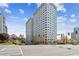 View of The Regency building featuring an expansive front lawn and city views at 2479 Peachtree Ne Rd # 1703, Atlanta, GA 30305
