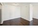 Empty living room featuring dark hardwood floors, white walls, and a ceiling light at 2479 Peachtree Ne Rd # 1703, Atlanta, GA 30305