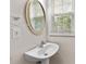Small bathroom with a sink, window, and neutral wall color at 6057 Glencedar Ln, Atlanta, GA 30349