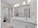 Bright bathroom features a double vanity with white cabinetry and a large mirror at 6057 Glencedar Ln, Atlanta, GA 30349