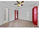 Empty bedroom with carpet, red shelving, and a doorway, ready for personalization at 6057 Glencedar Ln, Atlanta, GA 30349