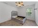 Simple bedroom with neutral carpet, one window, and a ceiling fan with light at 6057 Glencedar Ln, Atlanta, GA 30349
