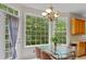 Breakfast nook featuring ample natural light and a glass top table, creating an inviting dining space at 6057 Glencedar Ln, Atlanta, GA 30349