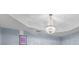 Striking room highlights a glamorous chandelier and a sophisticated tray ceiling at 6057 Glencedar Ln, Atlanta, GA 30349