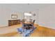 Bright dining room featuring pristine hardwood floors, modern chandelier, and furniture at 6057 Glencedar Ln, Atlanta, GA 30349