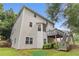 The exterior of this two-story home showcases a deck with backyard access and mature trees at 6057 Glencedar Ln, Atlanta, GA 30349