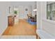 Inviting foyer featuring pristine hardwood floors and an open view into the dining and living spaces at 6057 Glencedar Ln, Atlanta, GA 30349