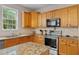 Well-equipped kitchen with light wood cabinetry, granite countertops, and stainless steel appliances at 6057 Glencedar Ln, Atlanta, GA 30349