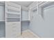 Well-organized walk-in closet with shelves, drawers, and hanging rods at 6057 Glencedar Ln, Atlanta, GA 30349