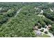 An aerial view of the house nestled amongst trees and a creek at 6185 Masters Club Dr, Suwanee, GA 30024