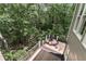Wooded backyard with multilevel deck, grill, and outdoor oven at 6185 Masters Club Dr, Suwanee, GA 30024
