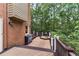 Multi-level deck with outdoor kitchen and view of wooded property at 6185 Masters Club Dr, Suwanee, GA 30024