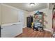Basement storage area with wood floors, shelving, and a black safe at 6185 Masters Club Dr, Suwanee, GA 30024