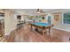 Spacious basement featuring a pool table, bar with stools, and a television, perfect for entertaining guests at 6185 Masters Club Dr, Suwanee, GA 30024