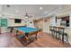 Spacious basement featuring a pool table, bar with stools, and a television, perfect for entertaining guests at 6185 Masters Club Dr, Suwanee, GA 30024