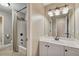 Neutral bathroom featuring a tub/shower combo, single sink vanity, and an oversized, framed mirror at 6185 Masters Club Dr, Suwanee, GA 30024