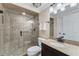 Bathroom with tiled walk-in shower, granite counter, and modern fixtures at 6185 Masters Club Dr, Suwanee, GA 30024