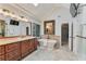 Bright bathroom featuring a freestanding tub, granite counters, skylight and decorative stained-glass window at 6185 Masters Club Dr, Suwanee, GA 30024