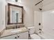 Bathroom with a granite-topped vanity, framed mirror, and shower-tub combination, offering a clean and functional space at 6185 Masters Club Dr, Suwanee, GA 30024