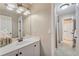 Neutral bathroom featuring a tub/shower combo, single sink vanity, and an oversized, framed mirror at 6185 Masters Club Dr, Suwanee, GA 30024