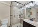 Modern bathroom featuring glass-enclosed shower, dark wood vanity, and neutral tile, adding sophistication and comfort at 6185 Masters Club Dr, Suwanee, GA 30024