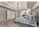 Large bedroom with decorative ceiling and lighting, neutral paint and plenty of natural light at 6185 Masters Club Dr, Suwanee, GA 30024