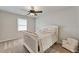 Cozy bedroom with neutral paint, lots of natural light and carpet flooring at 6185 Masters Club Dr, Suwanee, GA 30024