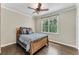 Inviting bedroom with hardwood floors and a large window with a peaceful view at 6185 Masters Club Dr, Suwanee, GA 30024