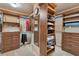 Custom designed walk-in closet with built in shelving and plenty of storage at 6185 Masters Club Dr, Suwanee, GA 30024