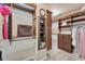 Custom designed walk-in closet with built in shelving, a mirror and plenty of storage at 6185 Masters Club Dr, Suwanee, GA 30024