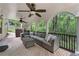 Covered deck with ample seating and views of a lush, wooded backyard at 6185 Masters Club Dr, Suwanee, GA 30024