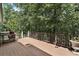 Large wooden deck perfect for outdoor entertaining, surrounded by lush greenery and offering serene views at 6185 Masters Club Dr, Suwanee, GA 30024