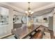 Open-concept dining area adjacent to the kitchen and living room, showcasing a farmhouse table and stylish decor at 6185 Masters Club Dr, Suwanee, GA 30024