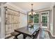 Dining room featuring a farmhouse-style table, chandelier, and sliding barn door, creating a rustic yet elegant space at 6185 Masters Club Dr, Suwanee, GA 30024