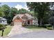 Charming two-story brick home with a well-manicured lawn and attached two-car garage at 6185 Masters Club Dr, Suwanee, GA 30024