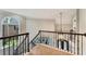 Bright foyer featuring elegant staircase with wrought iron spindles and large arched window at 6185 Masters Club Dr, Suwanee, GA 30024