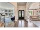 Elegant foyer featuring hardwood floors, arched doorways, and a view into the living area at 6185 Masters Club Dr, Suwanee, GA 30024