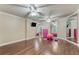 Home gym features mirrored walls, with exercise equipment, ceiling fans, and luxury vinyl flooring at 6185 Masters Club Dr, Suwanee, GA 30024