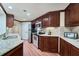 Charming kitchen featuring granite countertops, stainless steel appliances, and wood cabinets with ample storage at 6185 Masters Club Dr, Suwanee, GA 30024